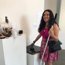 Lindsay Yazzolino touching a tactile bird